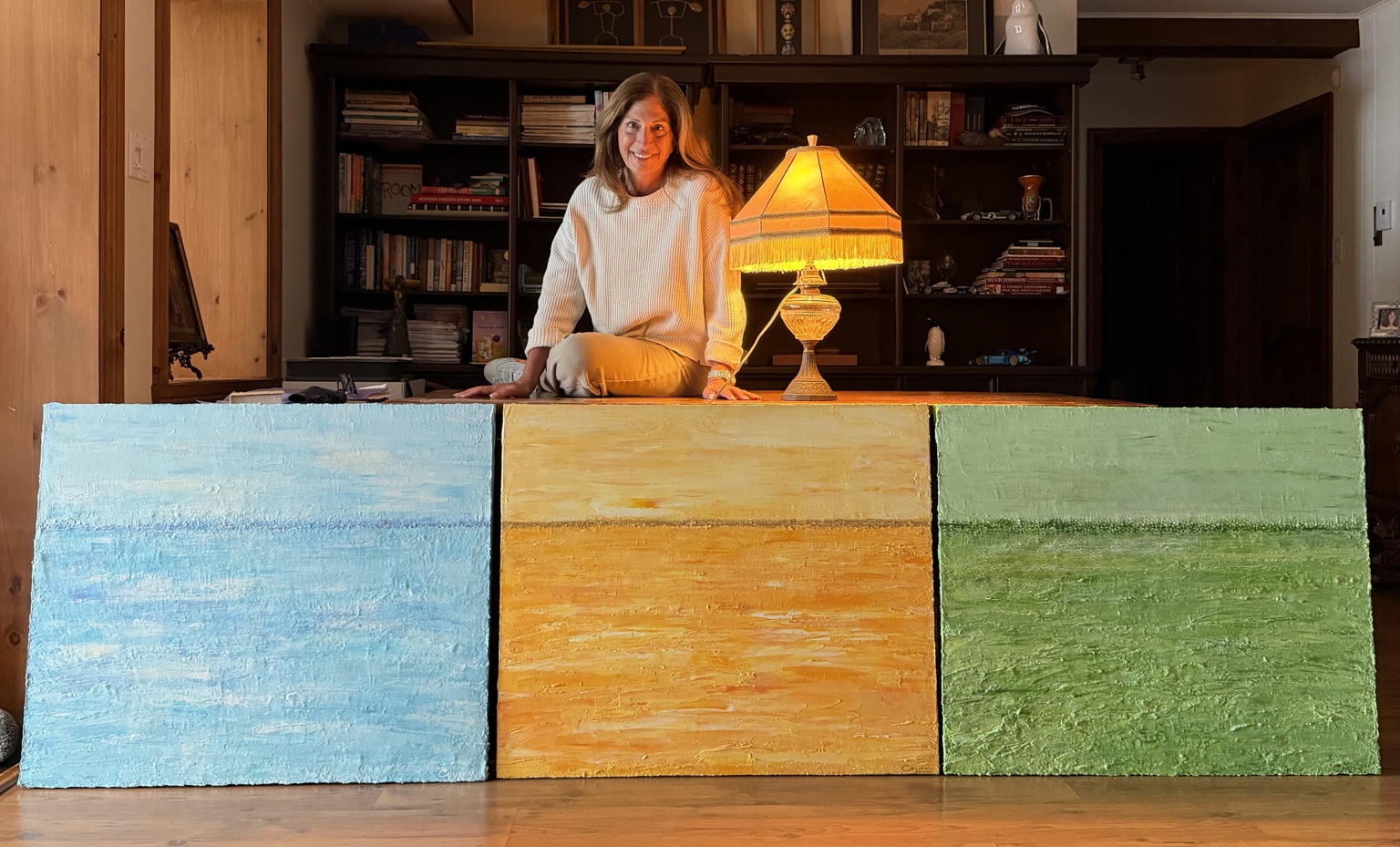 Louise Courey with Serenity, Radiance and Awakening, three coordinated original acrylic impasto paintings commissioned for the spa at Manoir Saint-Sauveur